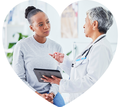 heart-allcare-concern A female curiously listening to her doctor.