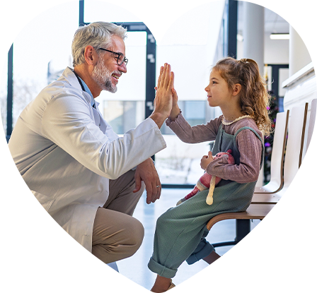 A doctor giving a high five to his pediatric patient.
