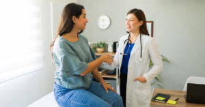 Woman shaking hands with her physician