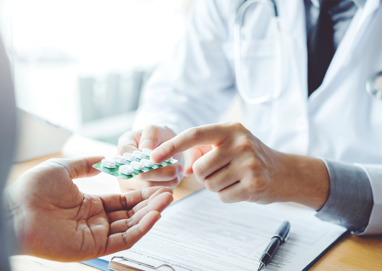 Doctor or physician recommend pills medical prescription for the flu to male patient.