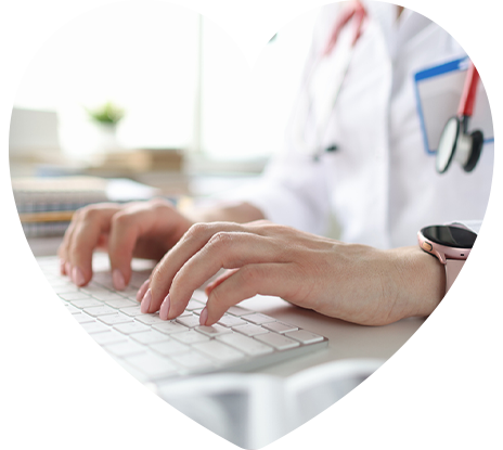 heart-allcare-concern A physician typing on a computer keyboard.